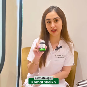 Dermatologist Dr Komal Sheikh holding NHC Ginkgo supplement bottle in clinic while explaining its benefits