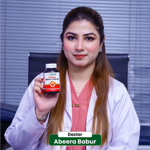 Doctor Abeera Babur holding NHC Numega Omega-3 Fish Oil softgels for healthy cholesterol and blood pressure