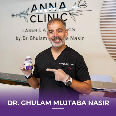 Dr. Ghulam Mujtaba pointing at NHC VitaBiotin 5000mcg biotin supplement bottle at Anna Clinic Laser and Aesthetics