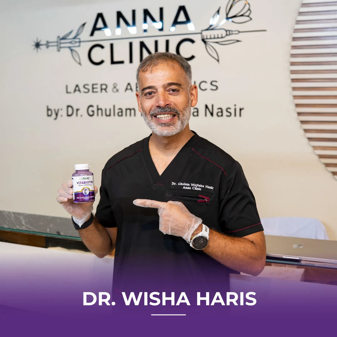  Dr. Wisha Haris pointing at NHC VitaBiotin 5000mcg biotin supplement bottle at Anna Clinic Laser and Aesthetics