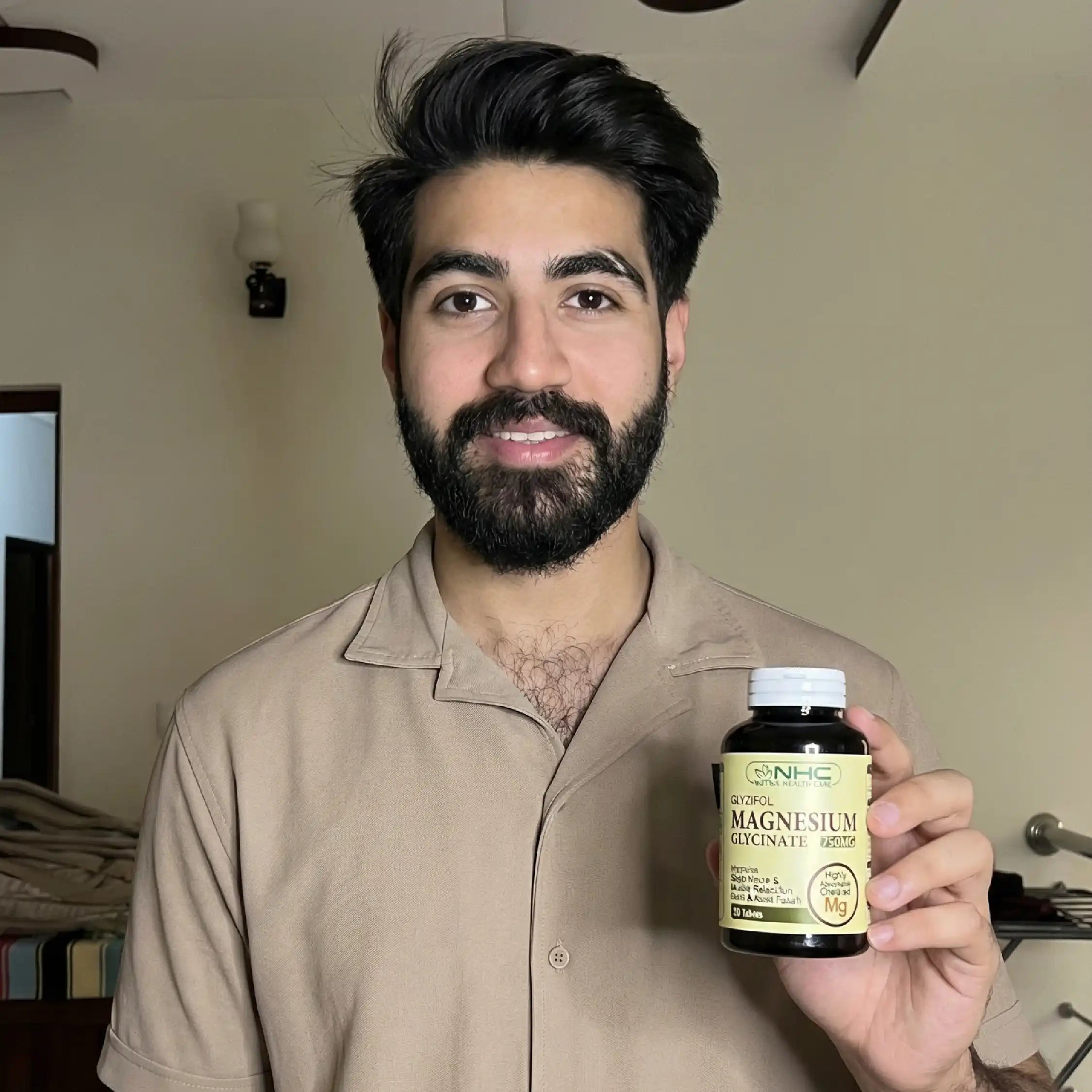 Man holding a bottle of magnesium supplement in a casual setting
