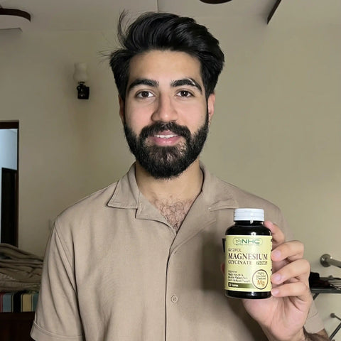 Man holding a bottle of magnesium supplement in a casual setting