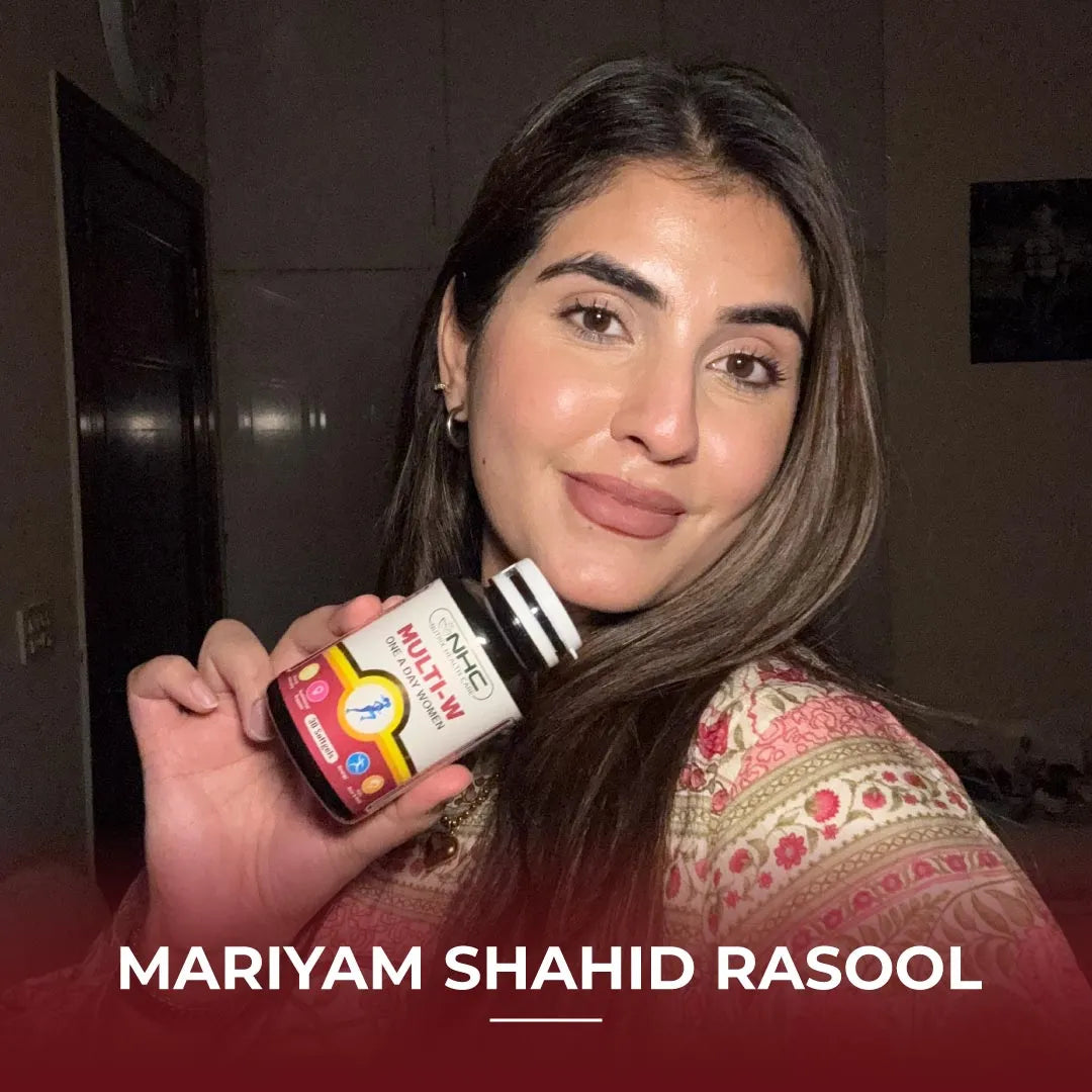 Mariyam Shahid Rasool holding NHC Multi-W One-A-Day Women multivitamin supplement bottle