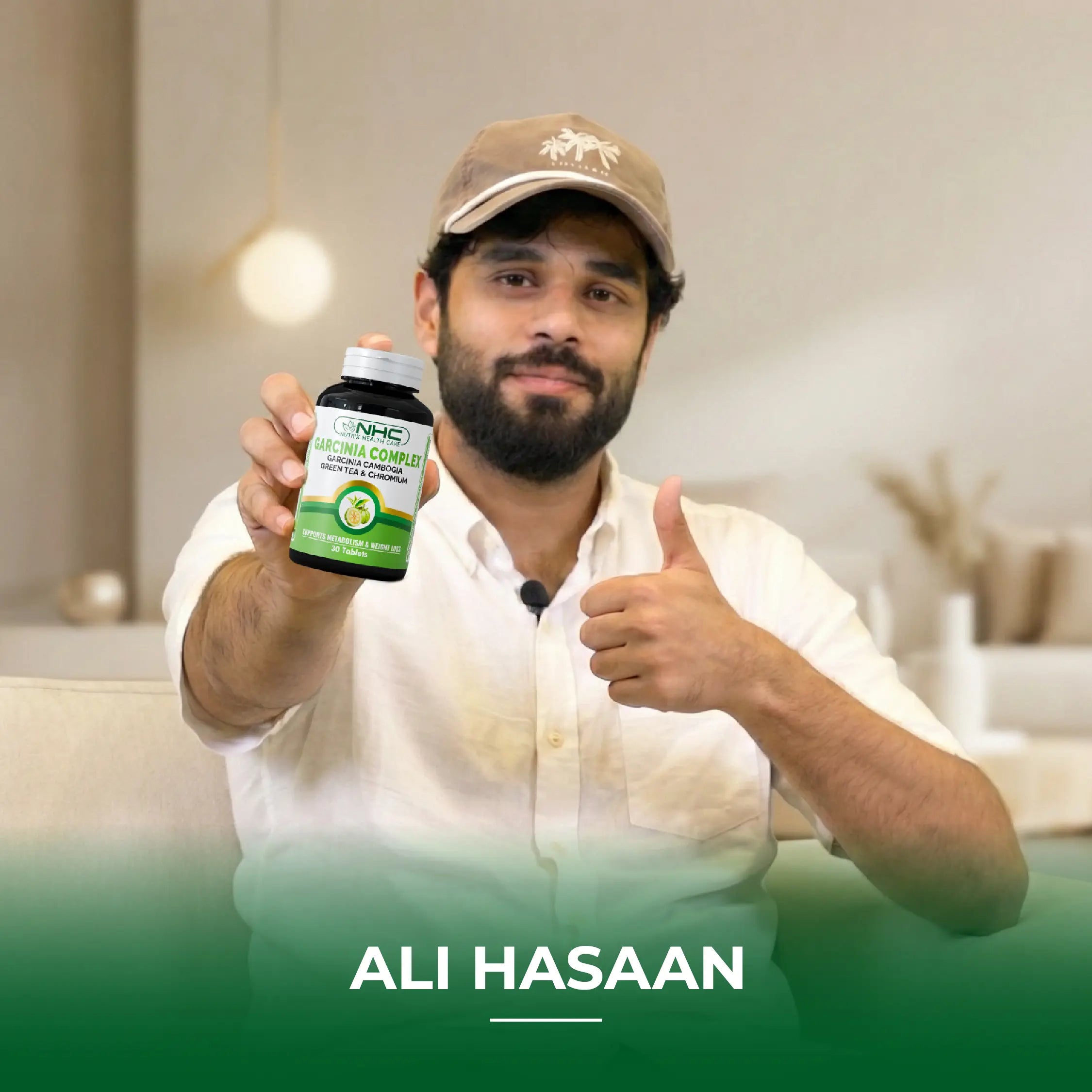 Ali Hasaan holding NHC Garcinia Complex supplement bottle with thumbs up
