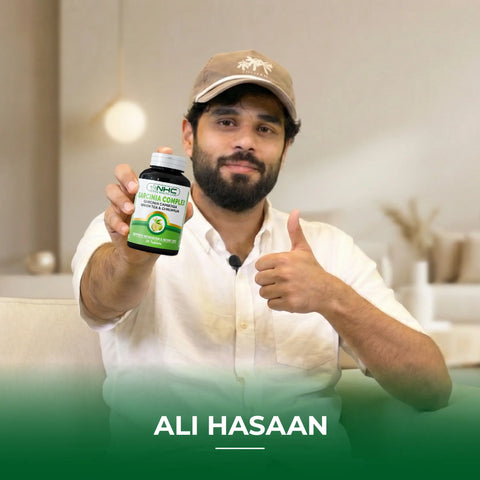 Ali Hasaan holding NHC Garcinia Complex supplement bottle with thumbs up