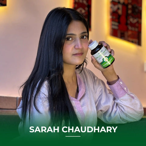 Sarah Chaudhary holding NHC Garcinia Complex supplement bottle