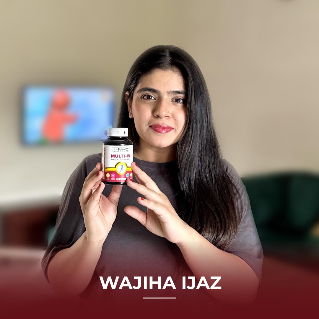 Wajiha Ijaz holding NHC Multi-W One A Day Women multivitamin supplement bottle