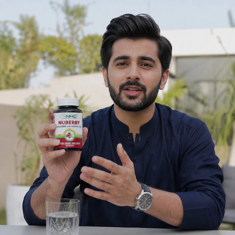 Man holding NHC Nuberry cranberry supplement bottle outdoors
