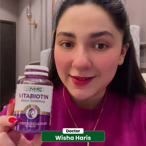 Doctor Wisha Haris holding NHC VitaBiotin Biotin 5000mcg 30 tablets bottle for beauty and wellness